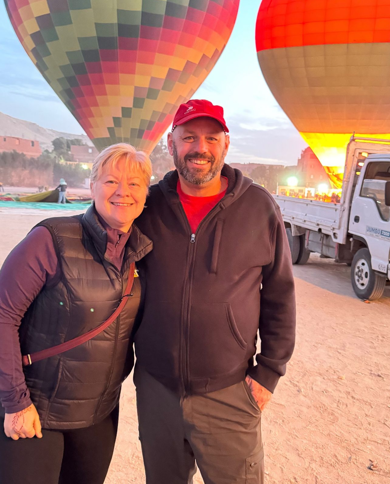 Helen King with a Viking guide beneath hot air balloons in Luxor, Egypt